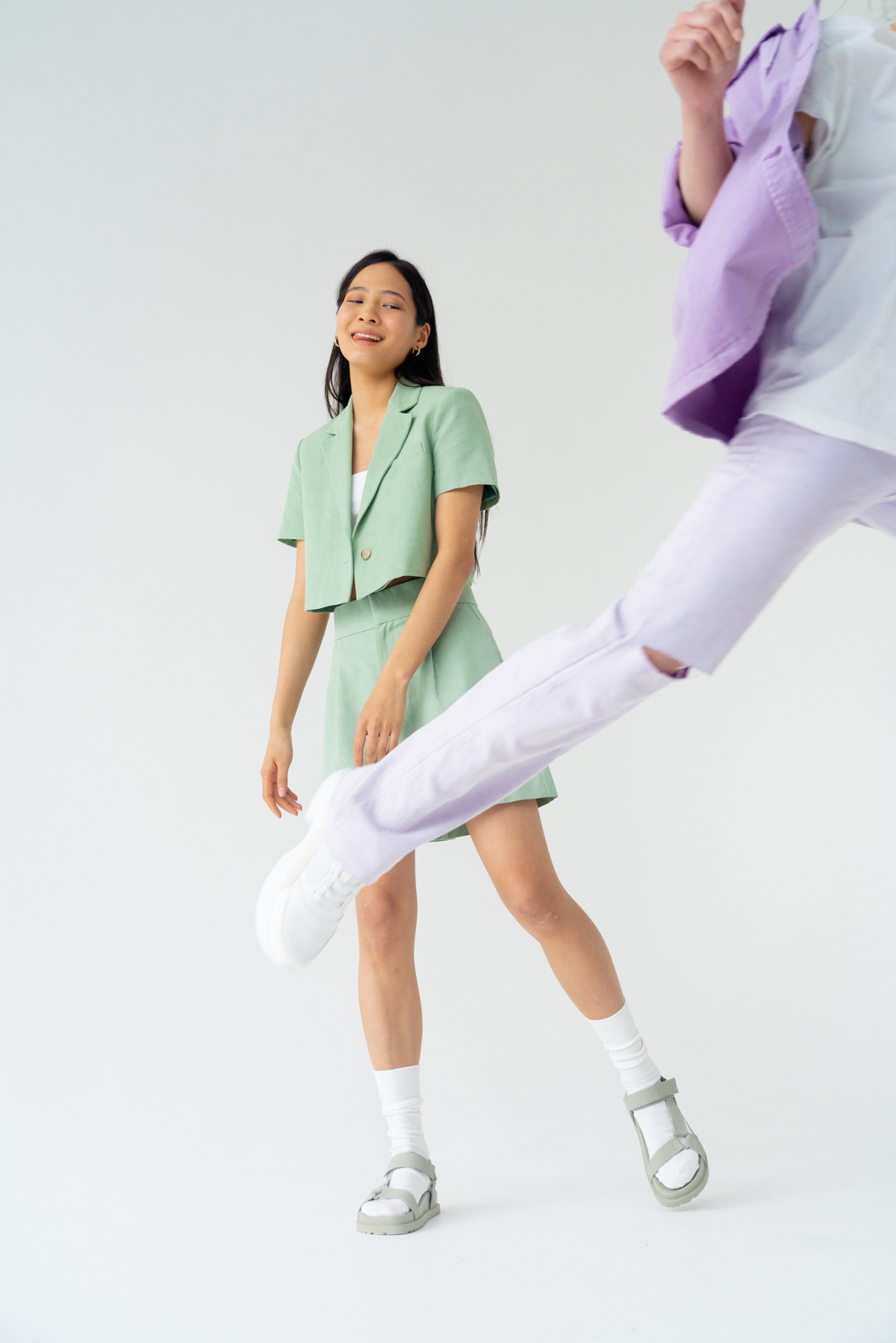 A Woman Standing while Wearing Pastel Green Clothes